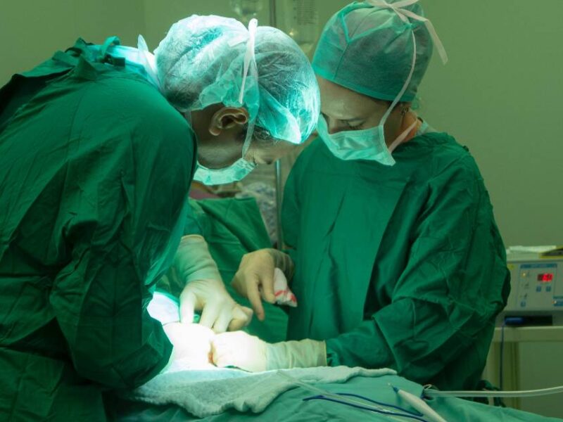 Doctors working on a patient in an operating room.