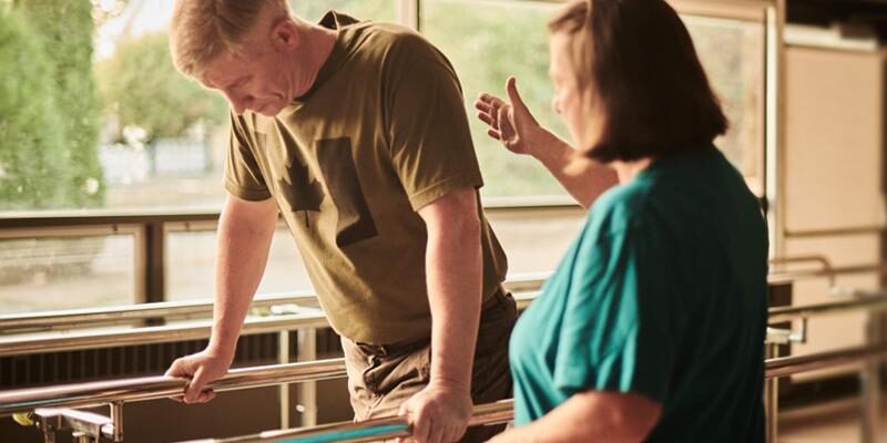 An image of a Canadian Armed Forces veteran doing walking exercises with a support worker.