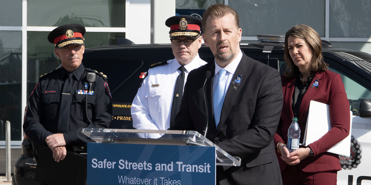 Alberta Public Safety Minister Mike Ellis hyperventilates about street crime at last Tuesday’s Law ’n’ Order press conference in Calgary as Calgary Police Chief Mark Neufeld, Edmonton Police Chief Dale McFee, and Premier Danielle Smith look on.