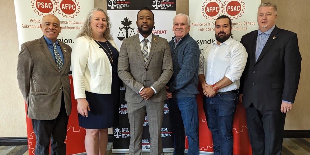 PIctured from left-to-right are: Larry Rousseau, Executive Vice President Canadian Labour Congress, Jennifer Carr, president of the Professional Institute of the Public Service of Canada, Nicholas Marcus Thompson Executive Director of the Black Class Action Secretariat, Chris Aylward National President of the Public Service Alliance of Canada, Alex Silas Regional Executive Vice President of PSAC and Marc Brière National President of the Union of Taxation Employees.