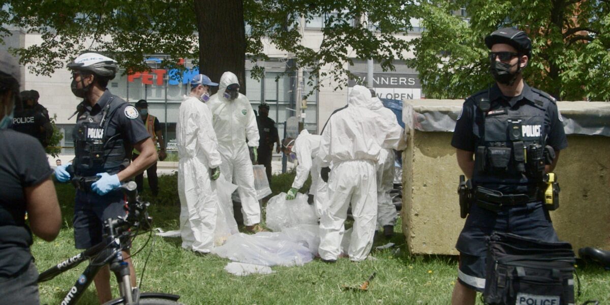 Police evicting houseless persons from encampments in Toronto.