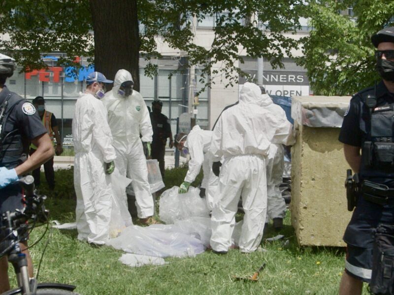 Police evicting houseless persons from encampments in Toronto.