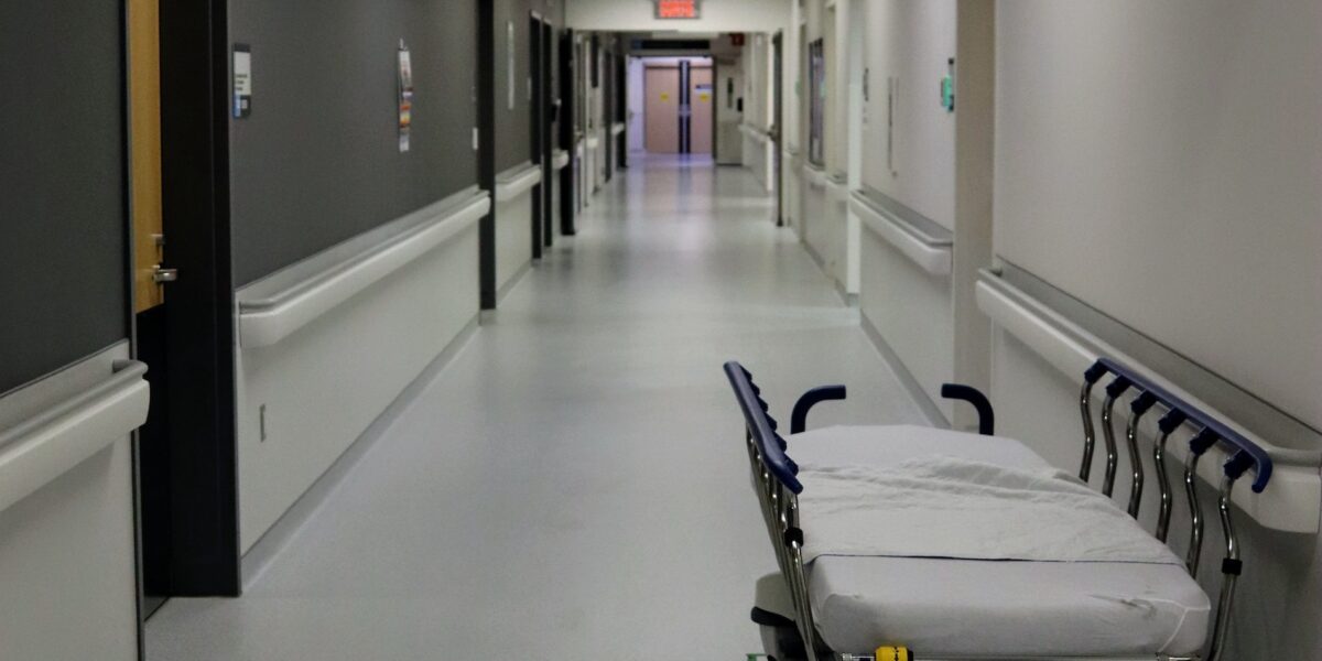 A photo of a gurney in the hall of a health-care facility.