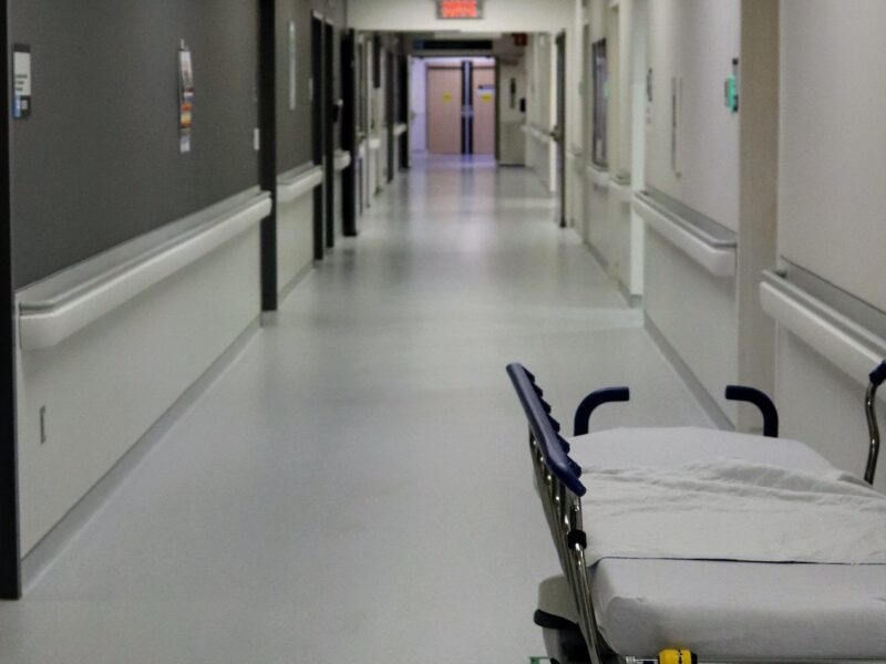 A photo of a gurney in the hall of a health-care facility.