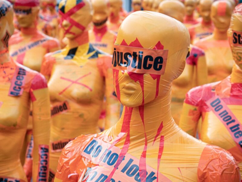 Mannequin with the word 'justice' covering its eyes