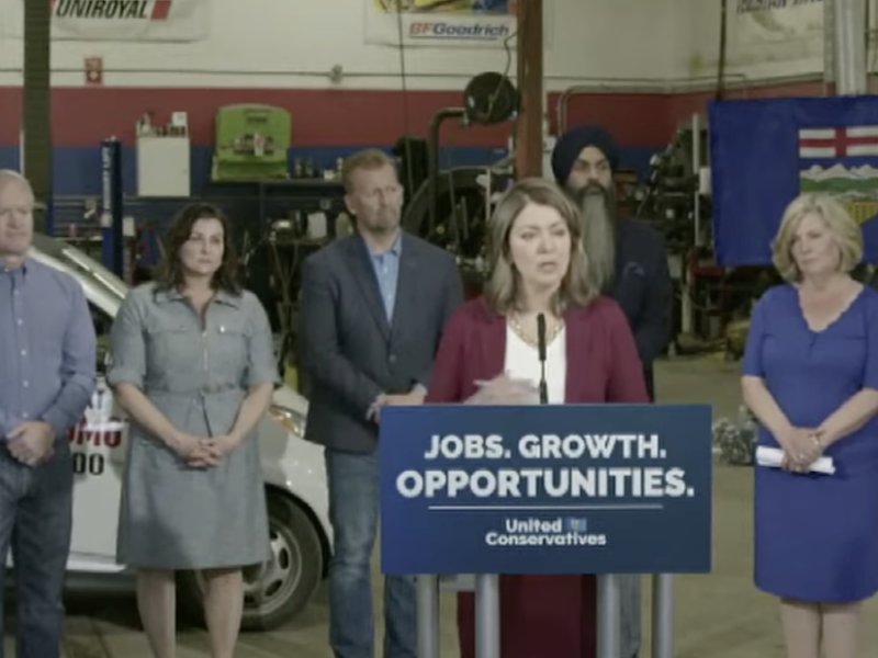 Alberta Premier Danielle Smith during her tire-repair-shop news conference yesterday (Photo: Screenshot of poor-quality UCP video).