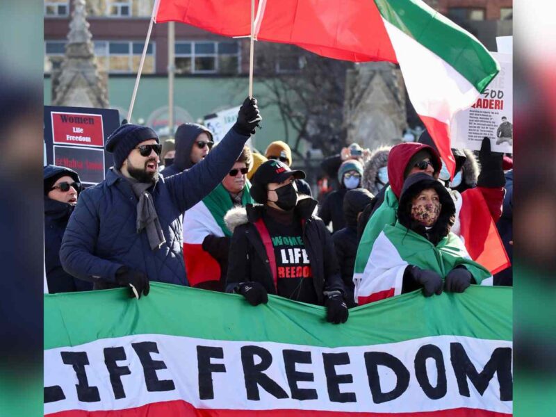 A photo of protesters waving Iranian flags during a Women Life Freedom protest that took place in Ottawa in December of 2022.