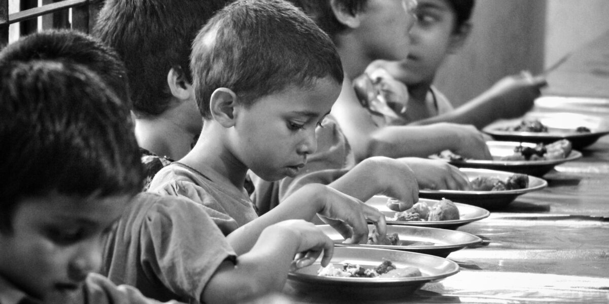 Children in Sylhet, Bangladesh, eat at a table in this undated photo.