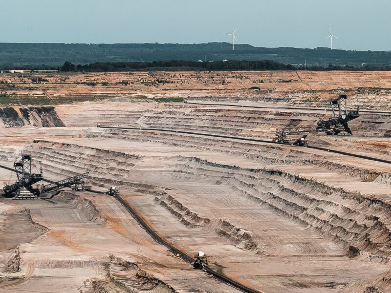 An image of a mining site with some truck in it.