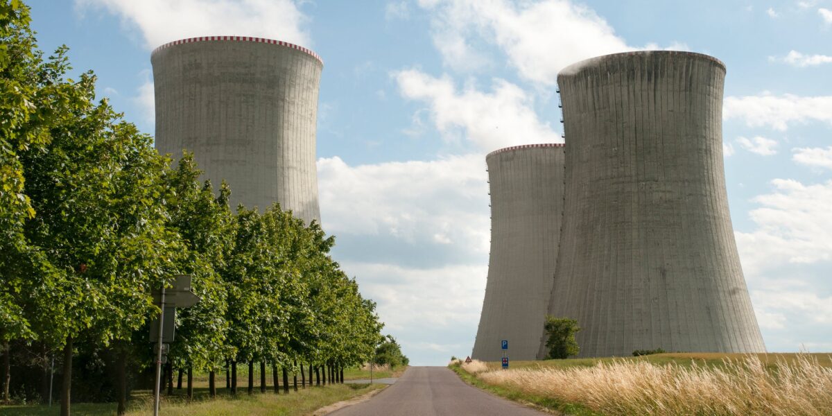 A gray road leads to a nuclear power plant