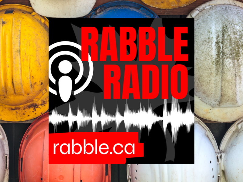 rabble radio logo and a row of multicoloured hardhats in background