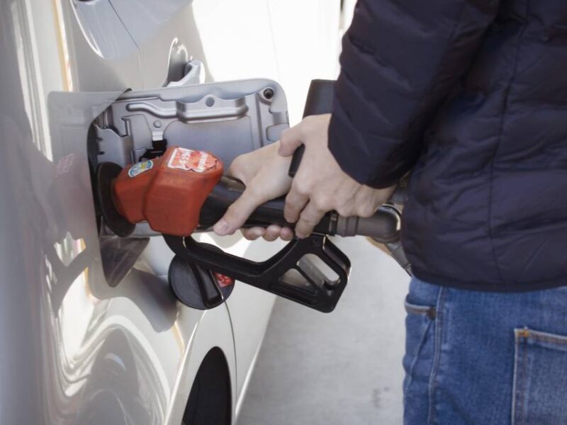 A picture of someone operating a gas pump.