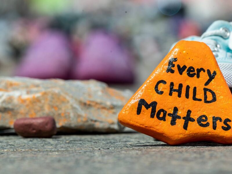 An orange stone reading Every Child Matters.