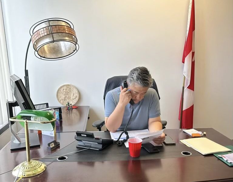 Independent MP Han Dong on the phone in his office.