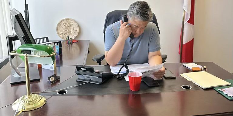 Independent MP Han Dong on the phone in his office.