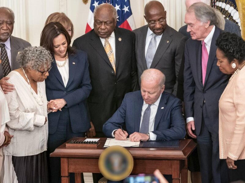 Joe Biden, surrounded by Black dignitaries, signing the law making Juneteenth a federal holiday in 2021.