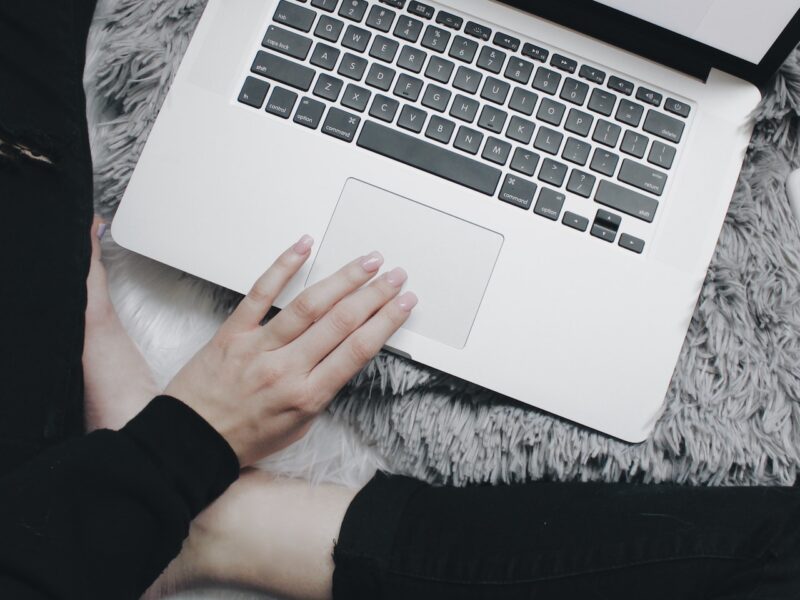 A person sits in front of a laptop computer as a moral panic spreads about sex work.