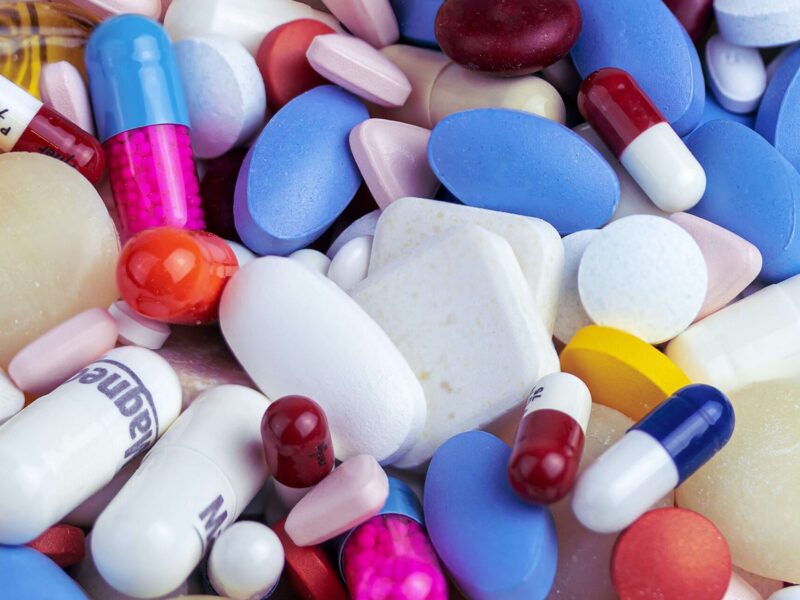 A variety of pills are seen in this photo.