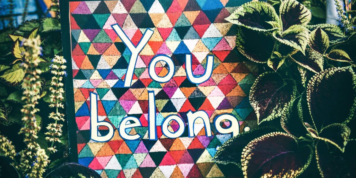 A patchwork quilt with the words "You Belong" stitched in.