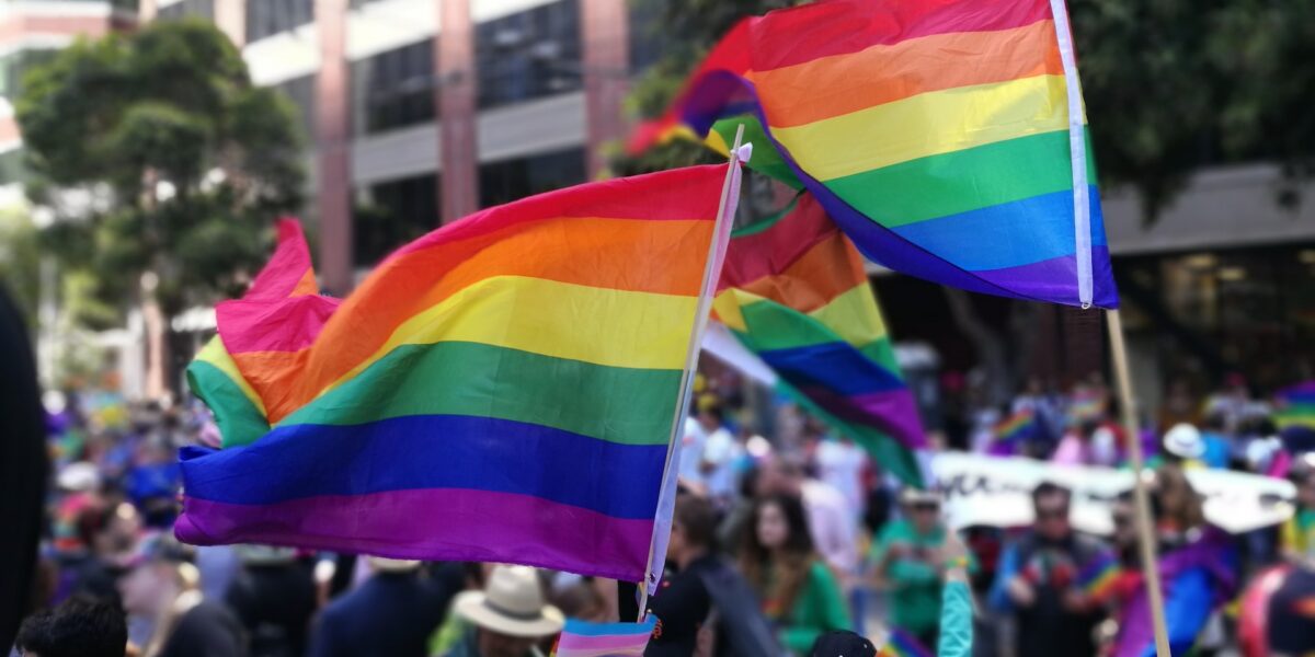 People wave Pride flags in support of LGBTQ rights at a march in San Francisco.