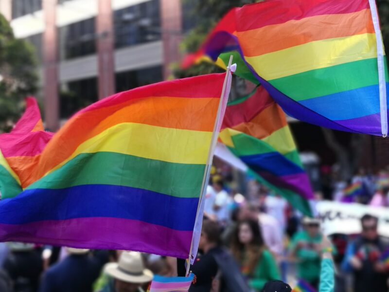 People wave Pride flags in support of LGBTQ rights at a march in San Francisco.