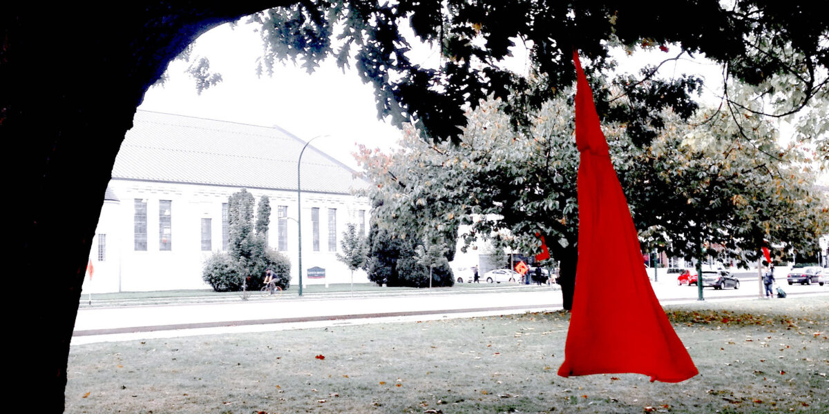 A red dress hangs from a tree as part of an art installation marking the National Day for Vigils for Missing and Murdered Indigenous Women and Girls, as loved ones seek to recover the bodies of MMIWG.