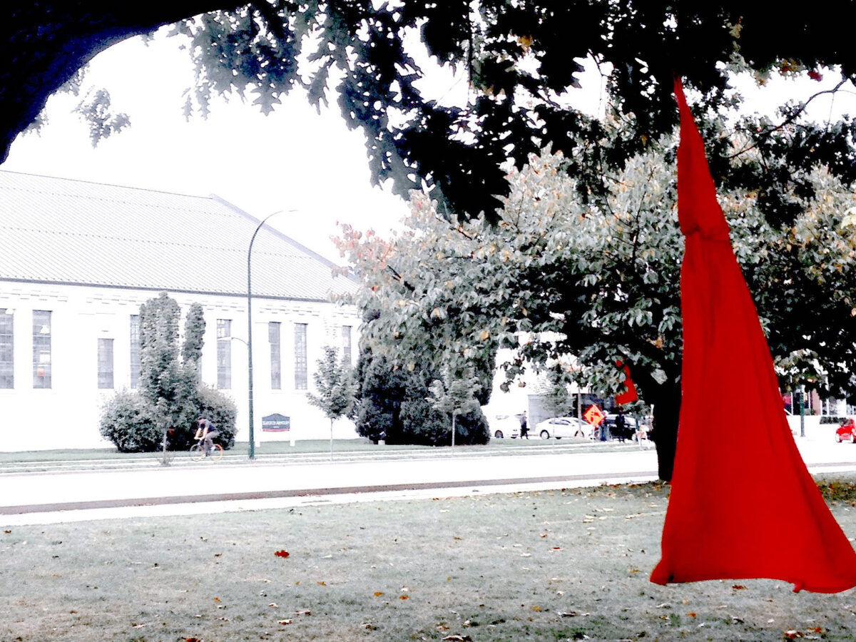 A red dress hangs from a tree as part of an art installation marking the National Day for Vigils for Missing and Murdered Indigenous Women and Girls, as loved ones seek to recover the bodies of MMIWG.