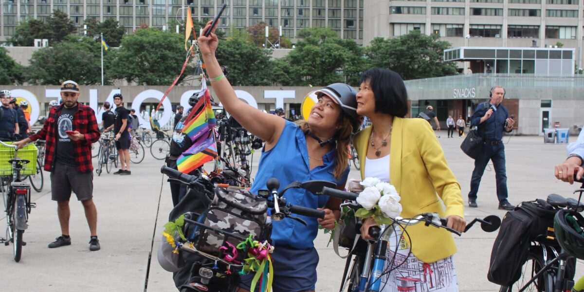 Olivia Chow taking a selfie with a fellow cyclist.