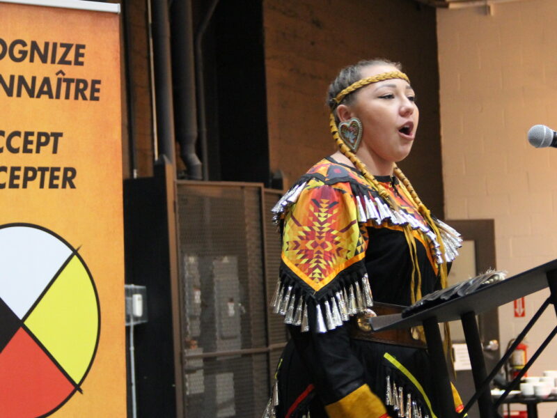 An image of an Indigenous Steelworker addressing the crowd at the union's National gathering.