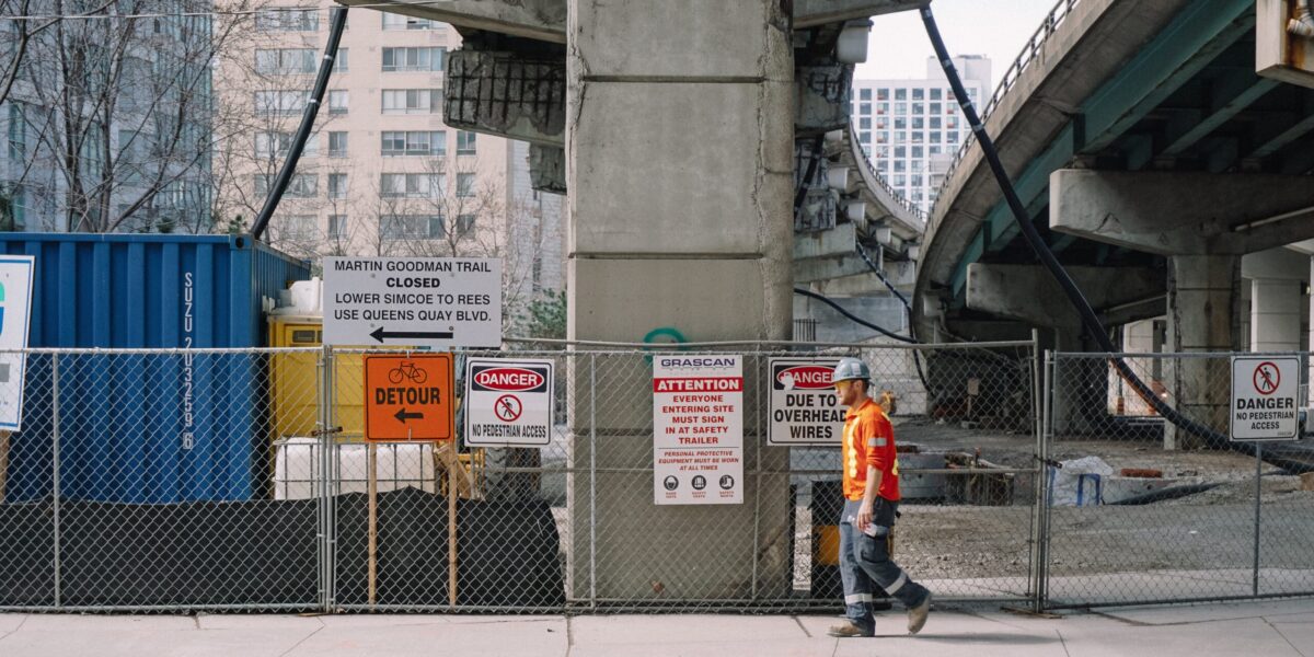 Construction and road closure signs under Toronto's Gardiner Expressway.