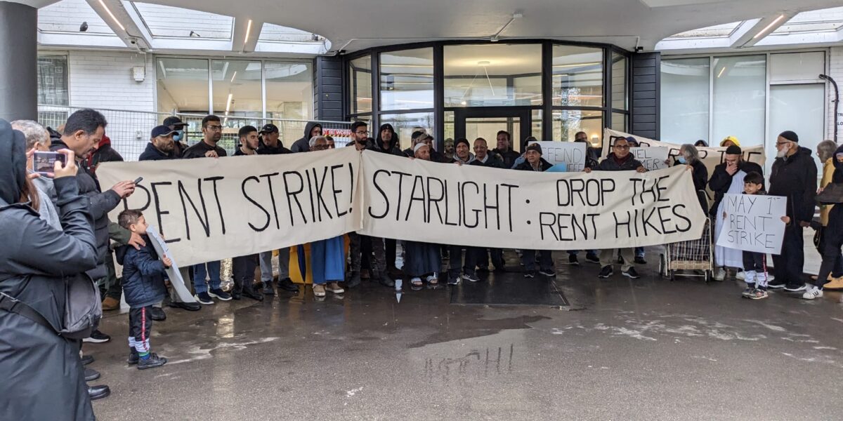 Thorncliffe Park Tenants holding a rally on May 1, 2023. They are holding a large banner that reads "Rent Strike! Starlight: Drop the rent hikes."