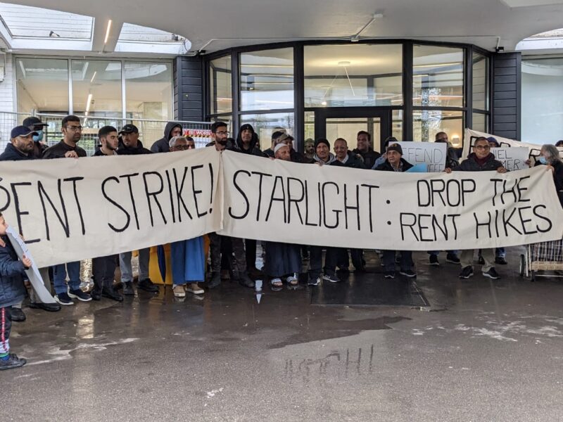 Thorncliffe Park Tenants holding a rally on May 1, 2023. They are holding a large banner that reads "Rent Strike! Starlight: Drop the rent hikes."