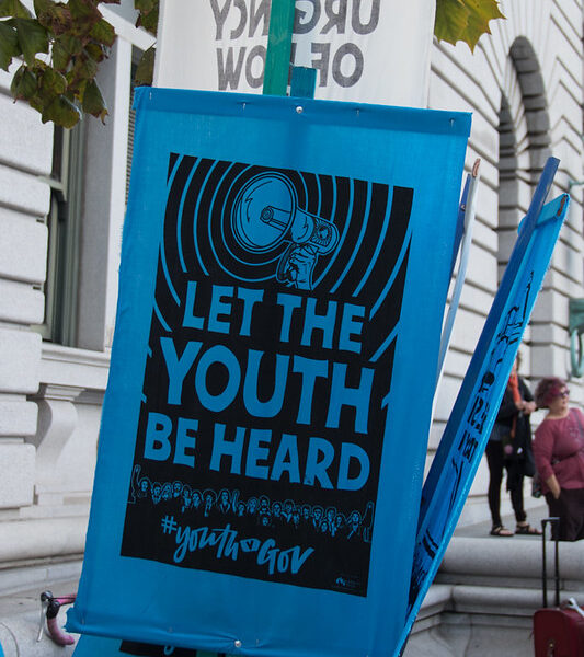 Sign reading "let the youth be heard"