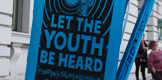 Sign reading "let the youth be heard"