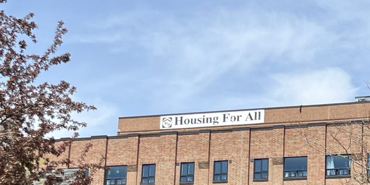 Building in St. Lawrence neighbourhood with banner reading "Housing for All."