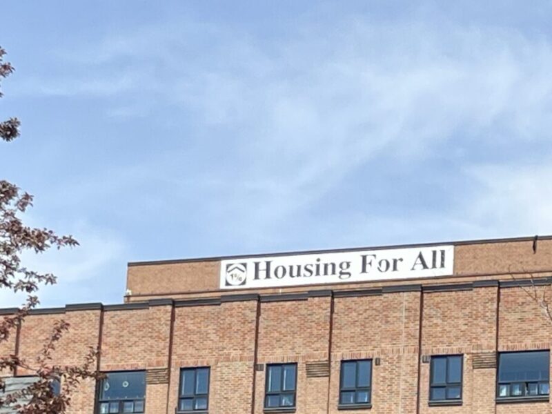 Building in St. Lawrence neighbourhood with banner reading "Housing for All."