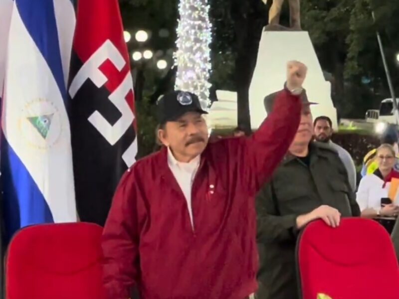 Daniel Ortega, president of Nicaragua, raises his hand in celebration.