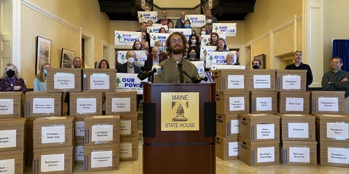 Supporters of Pine Tree Power deliver boxes of petitions with more than 80,000 signatures last fall to the Maine State Capitol in Augusta.