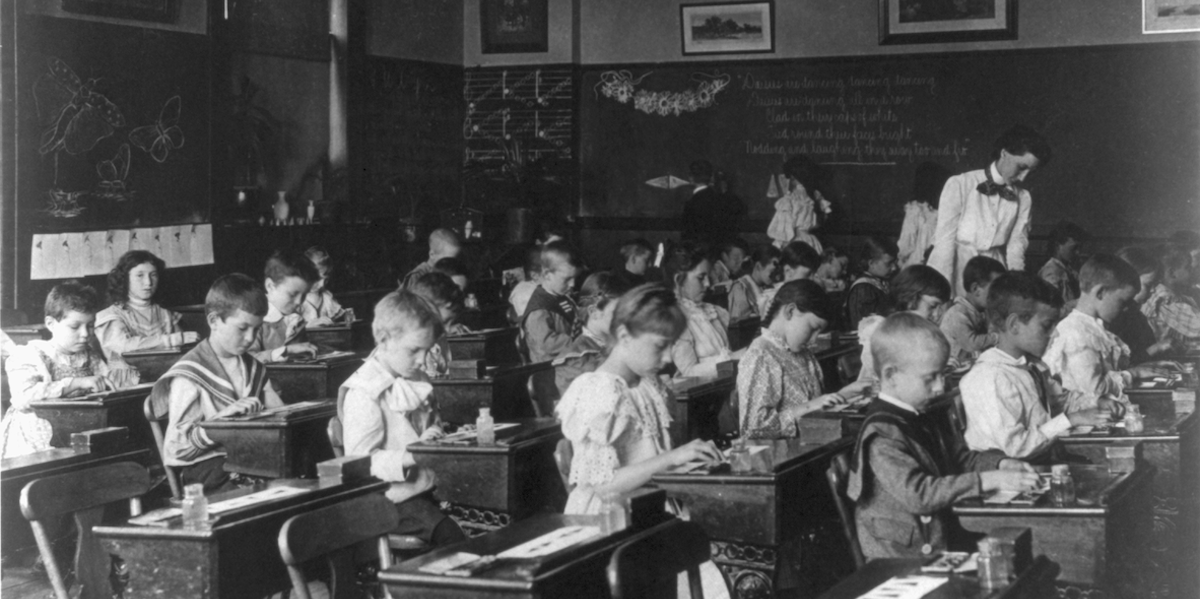 Black and white photograph of children in classroom.