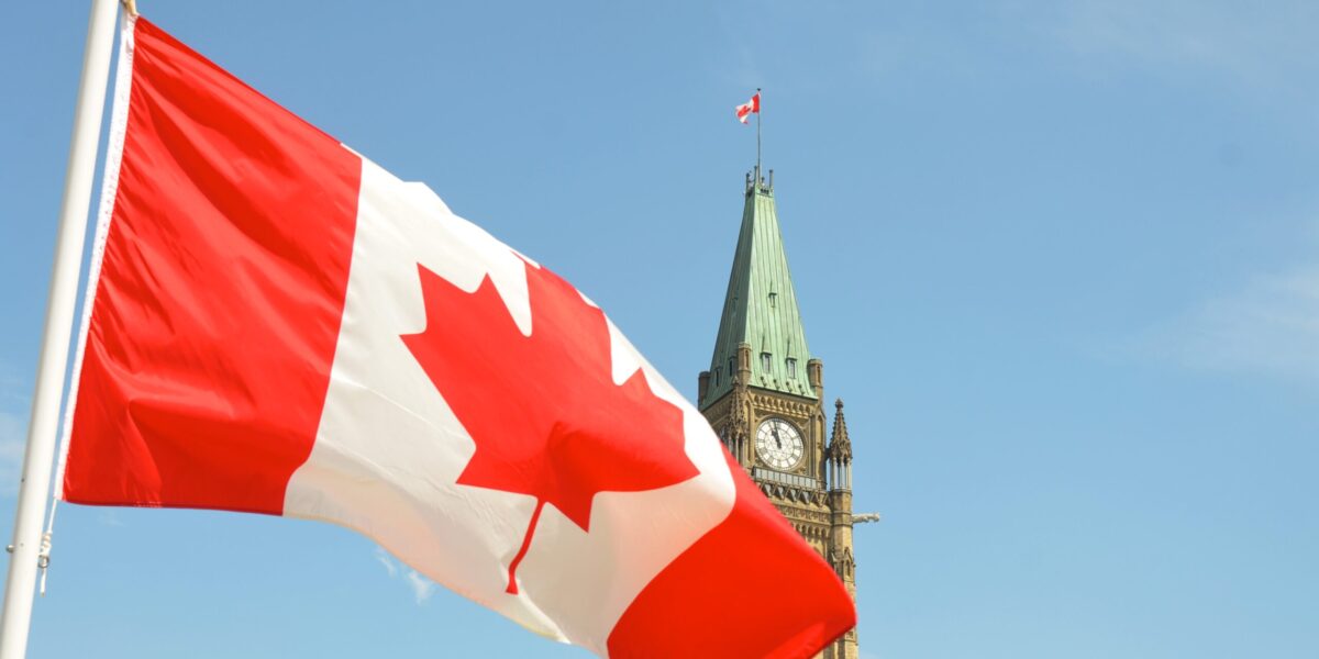 A Canadian flag flies in front of the Parliament building in Ottawa