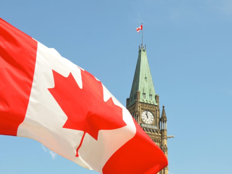 A Canadian flag flies in front of the Parliament building in Ottawa