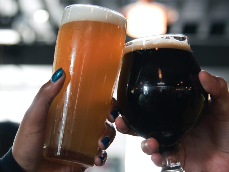 Two hands cheersing beers
