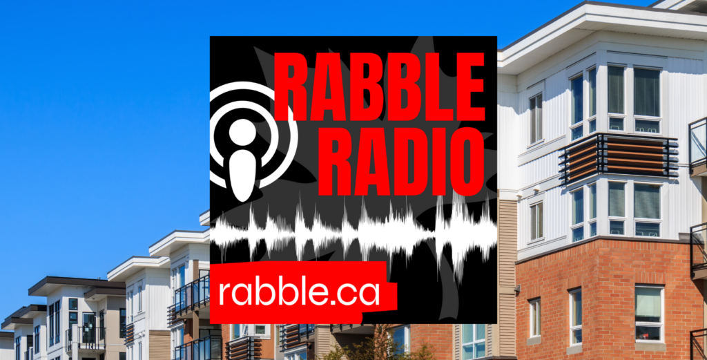 A photo of a line of apartments behind the rabble radio logo.