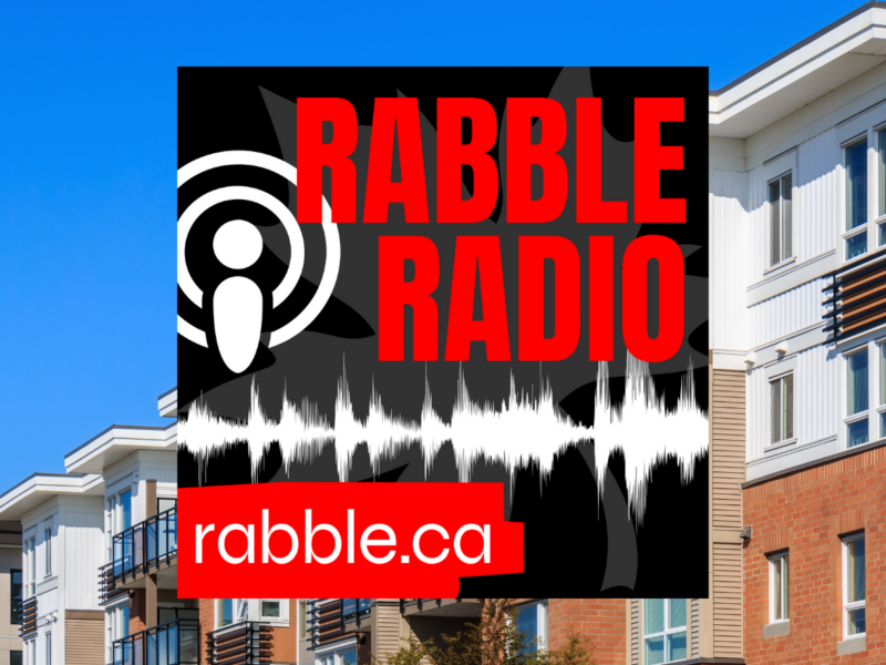 A photo of a line of apartments behind the rabble radio logo.
