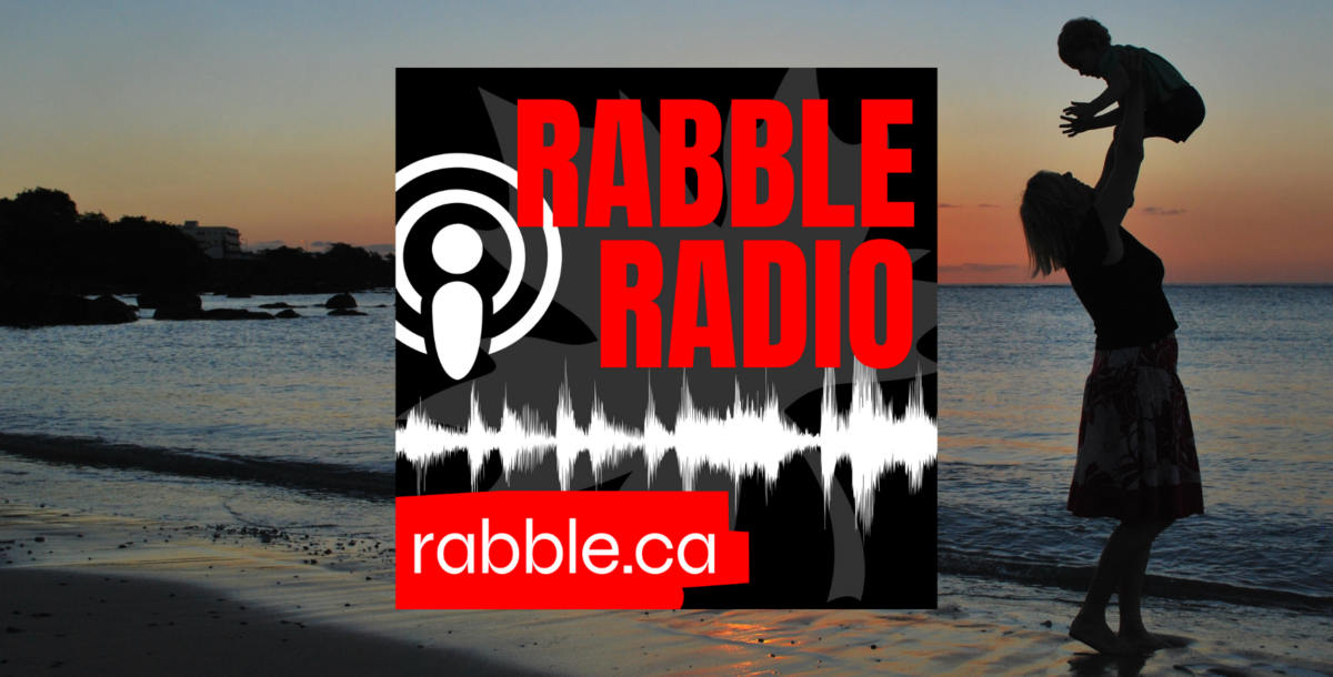A mother holding up her child in the air in the background of the rabble radio logo.