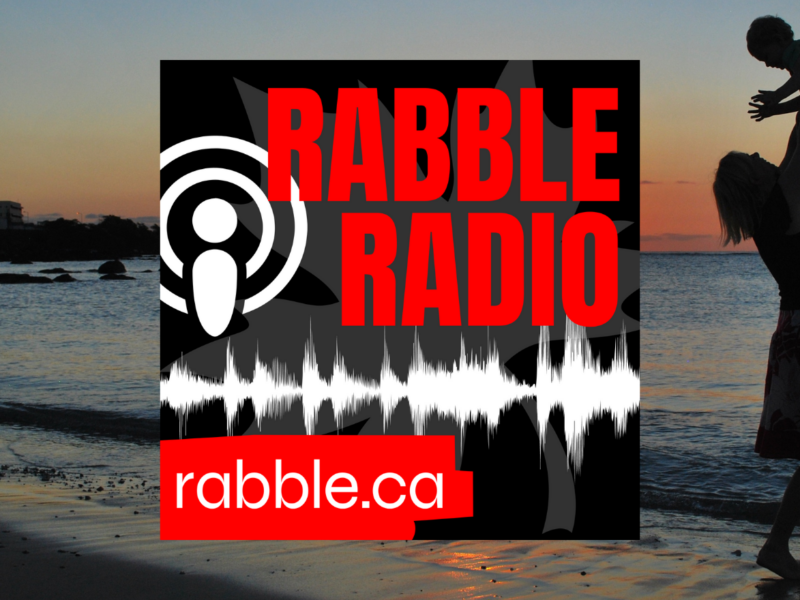 A mother holding up her child in the air in the background of the rabble radio logo.