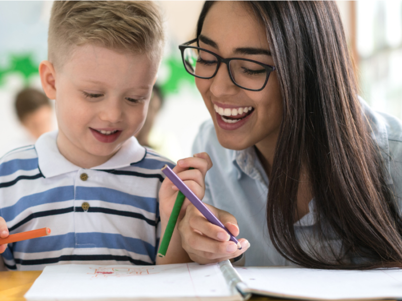 An image of a teacher working with a kindergarten age student.