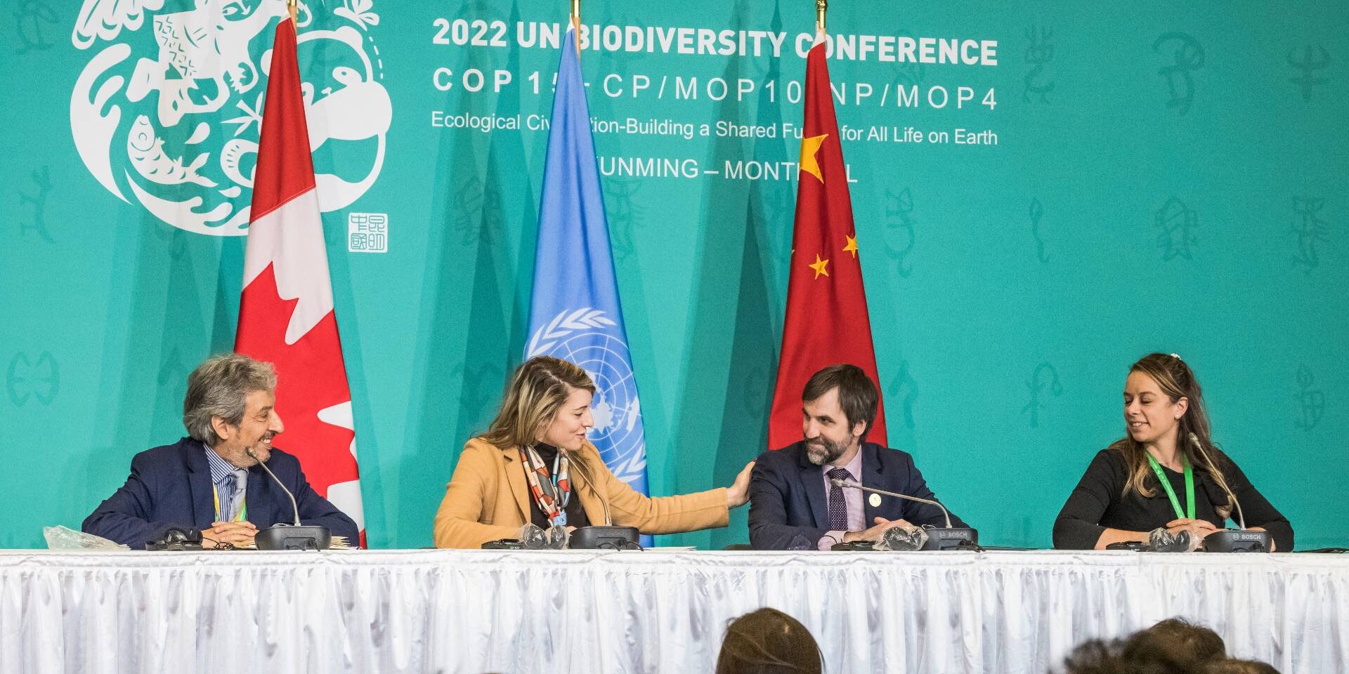 Canada's Global Affairs Minister Melanie Joly pats Environment Minister Steven Guilbeault on the shoulder at the COP15 summit in December of 2022.