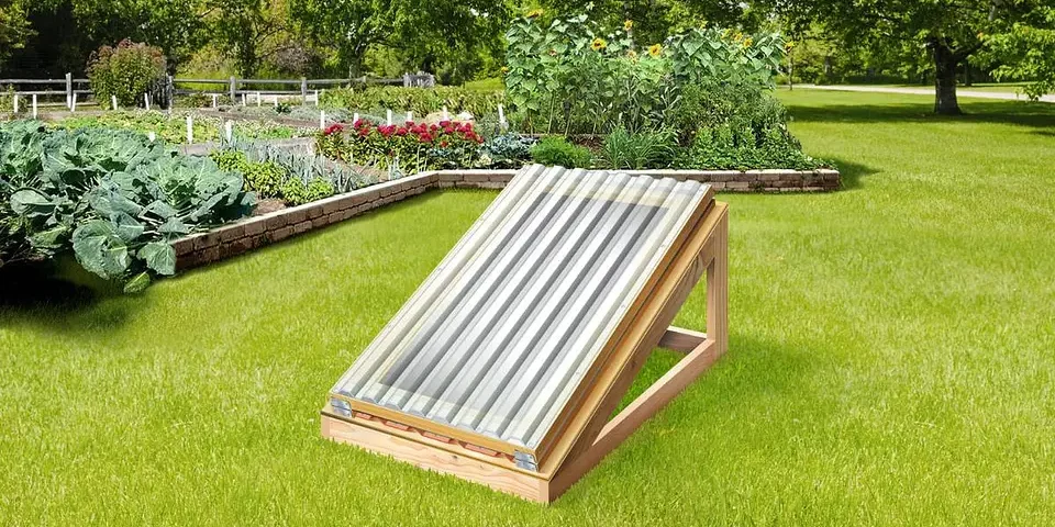 An image of a home made solar food dryer built of wooden beams and a plastic panel. This solar food dryer that does not need electricity and can produce a lot of dried food with just the sun!