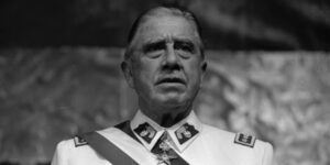 A black and white photo of Chilean dictator Augusto Pinochet.